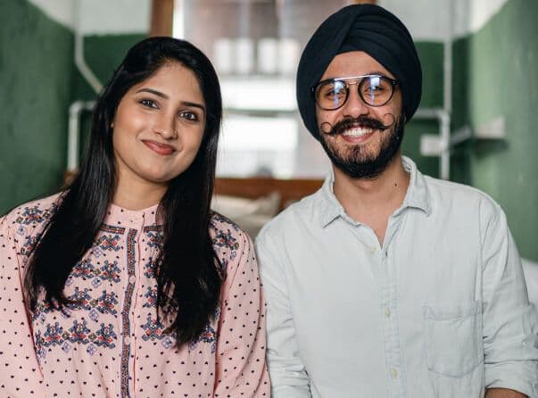 Man and woman standing side by side smiling